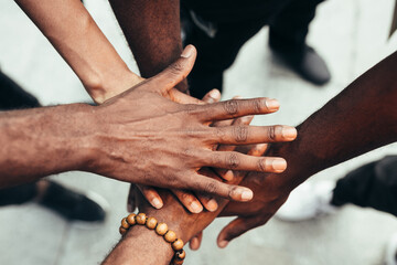 Group of friends stacking hands against racism. Black Lives Matters concept.