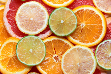 Fototapeta na wymiar Beautiful fresh sliced mixed citrus fruits like background. Concept of healthy eating, detox, diet. Top view.