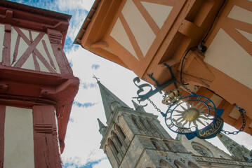 Fototapeta na wymiar Vannes church tower photographed between two typical Breton houses