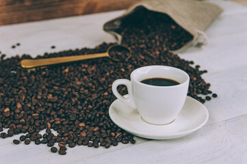 Cup for a drink with sugar on the background of coffee beans.