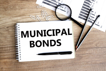 Municipal bond written on a memo stick and documents.