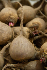 Dirty black beetroots in the grocery stock