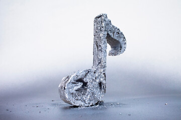 Close-up of concrete sixteenth note against gray background