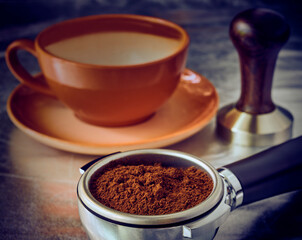 Ground coffee in a portofilter, temper and cup, espresso prepara