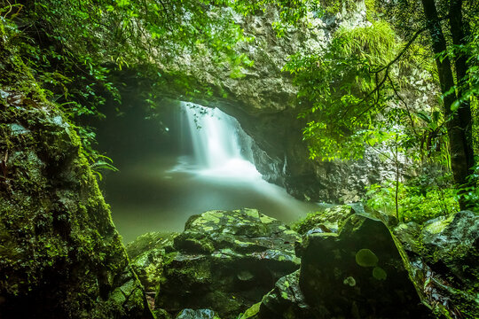The entrance to Natural Bridge in Springbrook National Park, Queensland viewed from a rocky vantage point
