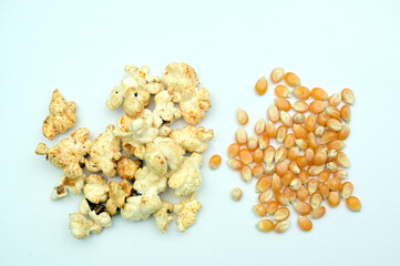 Popcorn and corn kernel on white background