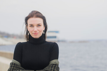 portrait of a young brown-haired girl in a black sweater, closeup.