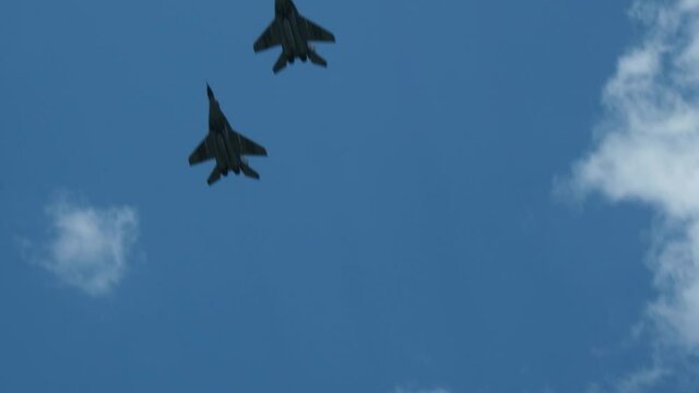 Column military warplanes flies over the ground in honor of the victory parade . Military planes in a beautiful blue sky. Air force parade.