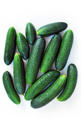Green cucumbers on a white background close-up.