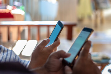 Business people using their smartphones at home. Teamwork group looking for information needed for working on the internet through mobile phones. Group of diverse hands using mobile. Close-up.
