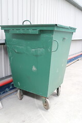 Green garbage bin in the hangar