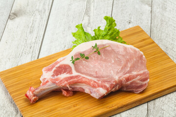 Raw pork bone steak over wooden