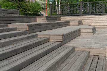 A multi-tiered wooden amphitheater near the riverbank.