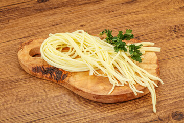 Chechil spaghetti cheese over board