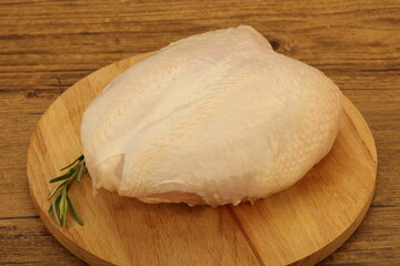 Fototapeta na wymiar Raw whole chicken breast with skin
