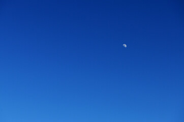 young moon in the blue sky without clouds in the style of minimalism