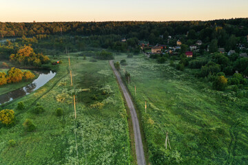 panoramic view of green meadows in the morning haze at sunrise shot from a drone at dawn
