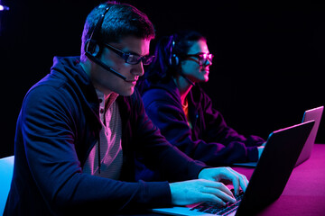 Caucasian man and a woman working late in an office