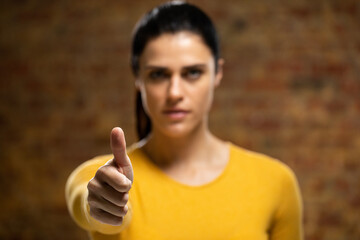 Caucasian woman with arm raised 