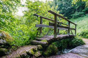 Wooden bridge over a stream in the nature