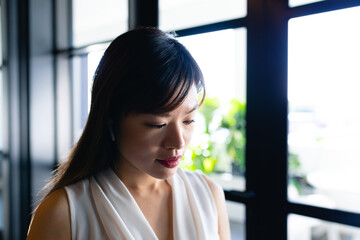 Asian woman looking down 