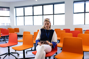 Caucasian woman in a conference room on her digital tablet