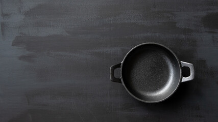 empty cast iron skillet with copy space on chalk board background 