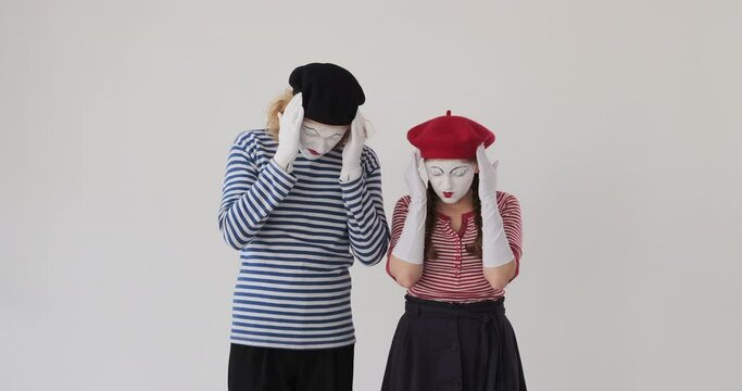 Sad mime artist couple in sorrow state of mind feeling bad and regretting the cause
