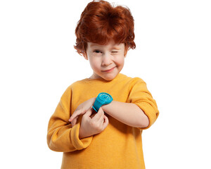 A child with a wristwatch. The red-haired boy shows the time on his watch and squints funny. Portrait of a happy child on a white background. Learning to determine time. Time management.