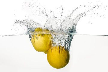 Freeze motion image of lemons splashing in water