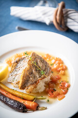 sea bass poele with white wine sauce, luxury restaurant style dish
