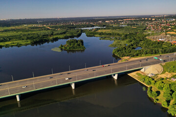 panoramic view of expressway across the river taken from a drone at dawn