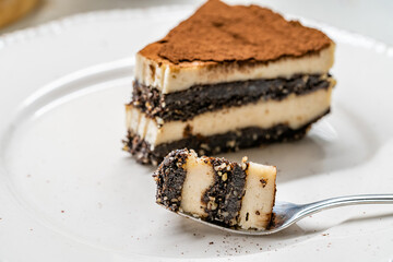 Vegan Dessert Tiramisu Bite on Fork with Date Fruit Paste, Cashew Cream, Coconut Milk and Espresso.