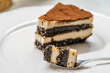 Vegan Dessert Tiramisu Bite on Fork with Date Fruit Paste, Cashew Cream, Coconut Milk and Espresso.