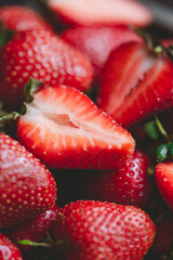 Fresh ripe organic strawberry background and cuted half closeup 