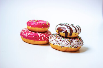 Doughnut with frosting. Dessert colorful snack. Glazed sprinkles. Sweet icing sugar food on white background. Close up.