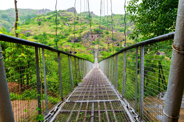 Suspension swinging bridge over the gorge in Armenia near the cave city Khndzoresk