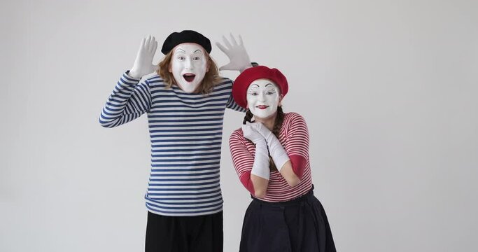Astonished mime artist couple looking at far end and celebrating success