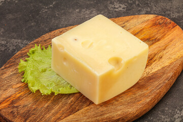 Emmental cheese over wooden board