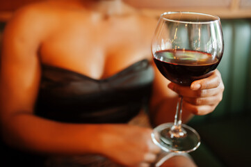 Close up glasses of wine against african american woman at restaurant.
