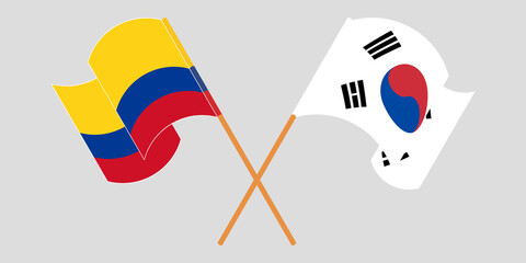 Crossed and waving flags of Colombia and South Korea