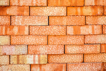 Red brick. Texture. Pallet of paving slab closeup on a construction site in sunny day. Paving slabs in the packaging at the construction site. Brick. Close-up.