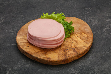 Sliced pork natural sausages over board