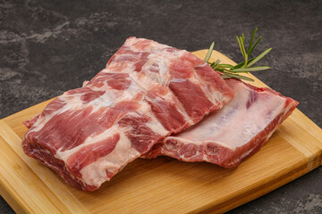 Raw pork ribs served rosemary