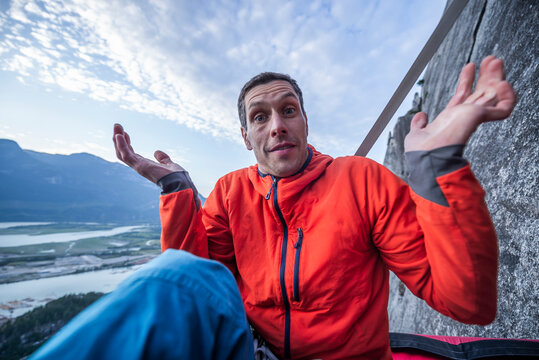 Man with surprised look showing interrogation on portaledge at sunset