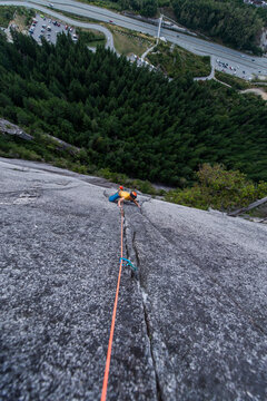 Man rock climbing cracks in granite very exposed in Squamish Chief