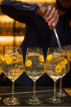 Barman is preparing a delicious cocktail with ice