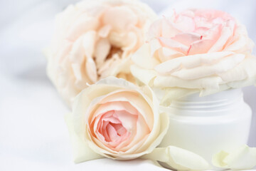 Natural cosmetics. Jar of rose cream on a white