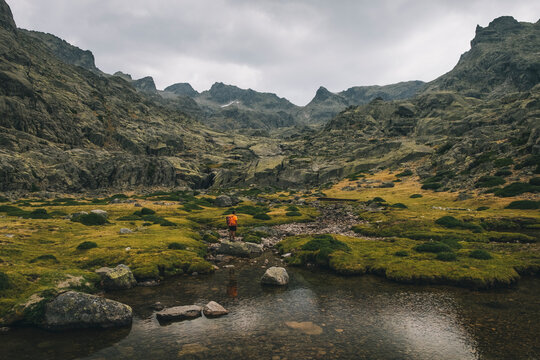A young man looks at his objetive to hike in Sierra de Gredos, Spain