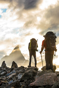 Rear view of two mountaineers hiking towards Mt. Loki, Baffin Island.